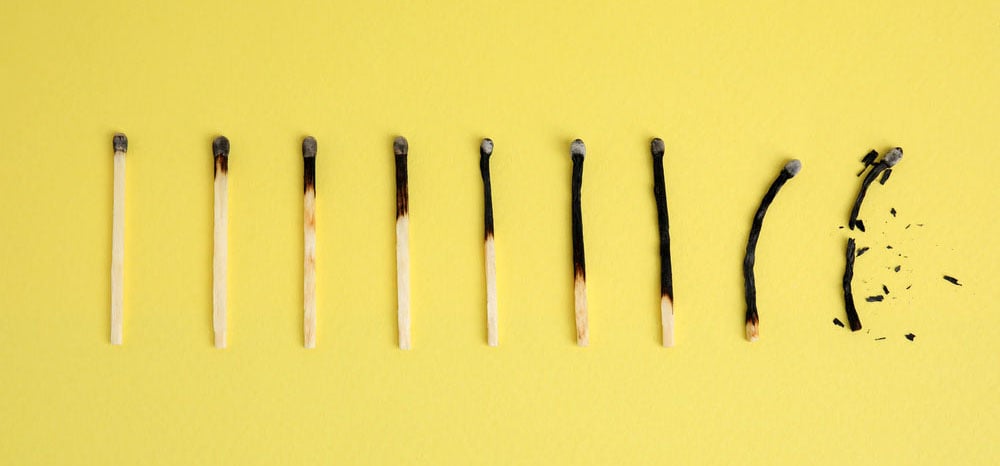 Different stages of burnt matches on yellow  background, flat lay